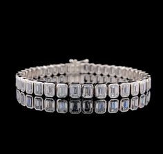 a white gold bracelet with square cut diamonds on the front and sides, set in 18k white gold