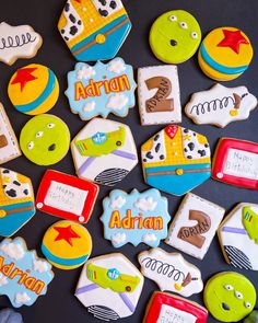 decorated cookies are arranged on a black surface