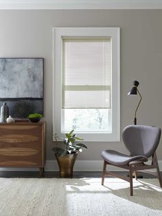 a living room with a chair and window