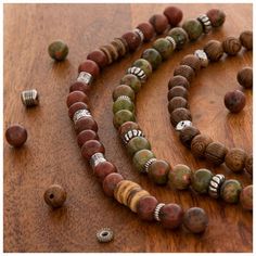 Upgrade your jewelry with these Wood & Stone Bead Strands. These strands feature wooden beads with a busy wood grain finish and stone beads in smooth greens, pinks, and reds. They are separated by stylish metal spacers. Work these beads into a bracelet or wrap them around a stylish necklace! Add new dimensions and depth to your next project with beads for every look. Details: 	 Strand Length: 7" 	 Smallest Bead Dimensions: 1.7mm x 5.7mm 	 Largest Bead Dimensions: 8.2mm x 8.2mm 	 Approximate Hole Nature-inspired Beaded Necklace With Wooden Beads, Brown Beaded Bracelets For Jewelry Making, Brown Gemstone Beads Bracelets For Jewelry Making, Brown Gemstone Beads For Jewelry Making, Nature-inspired Wooden Beaded Necklace, Bohemian Wood Beaded Bracelets, Wooden Beaded Necklaces With Round Beads, Wooden Beaded Bracelets With Round Beads, Brown Wooden Beads For Jewelry Making