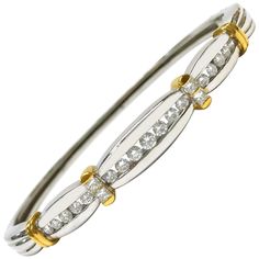 18 Karat Two-Tone white and yellow gold channel-set Diamond hinged bangle bracelet. Seventeen round graduate diamonds channel-set in white gold with yellow gold bands and four princess-cut Diamonds to accent the yellow gold bands. Diamonds are VS1-VS2 in clarity (G.I.A.) and G-H in color (G.I.A.) and have a total weight of 1.02ctw. The bangle is 2.58" wide and 2.23" deep. The bangle has a hinge on one side and opens at the other. Stamped on the inside of the bracelet are 18K and the maker's mark Diamond Bar Bracelet, Diamond Outline, Wire Bangle Bracelets, Diamond Bangle Bracelet, Vintage Bangles, Diamond Bangles Bracelet, Wire Bangles, Bezel Set Diamond, Gold Bangle Bracelet