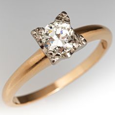 an old mine cut diamond engagement ring in yellow gold, set on a white background