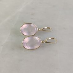 ITEM DESCRIPTION: >> The earrings are made from Solid 14K Yellow Gold. Gemstone used is absolutely natural and ethically sourced. >> Natural Rose Quartz in oval shape and bezel setting is studded on it with utmost precision with Lever back closure. >> This is a minimalist design and is absolutely hassle-free and everyday jewelry.  Gem: Rose Quartz Gem size: 13x18 mm  Gem weight: 26.65 carats Gold purity: 14K (58.33% approx.) Gold weight: 1.33 grams  Gross weight: 6.66 grams The Gold purity is guaranteed and it comes with authentic 14K gold hallmark. Since these Earrings are handmade, they are Nickel/Lead FREE.  CUSTOMIZATION: --> Pendant of the same design is also available on my Etsy Shop. --> You can choose your own gemstone. --> Kindly drop a message for more options. CUSTOMER SUPPORT: Pink Formal Hoop Earrings In Fine Jewelry Style, Pink Hoop Earrings For Formal Occasions, Classic Rose Gold Gemstone Earrings, Pink Round Hoop Earrings For Formal Occasions, Pink Round Hoop Earrings For Formal Events, Elegant 14k Gold Gemstone Hoop Earrings, Fine Jewelry Pink Briolette Earrings, Elegant Pink Gold Hoop Earrings, Pink Briolette Fine Jewelry Earrings