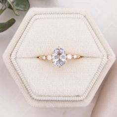 an engagement ring sits on top of a box