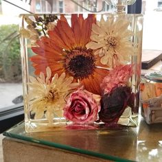 a vase with flowers in it sitting on a table