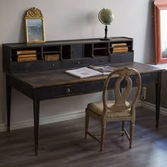 an old desk and chair in a room