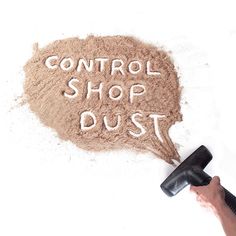 a hand holding a hair dryer sprays the word control shop dust in sand