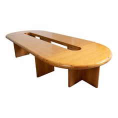 an oval shaped wooden table with two benches on one side and another bench at the other end