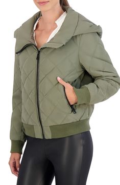 Stay warm in this water-resistant quilted bomber jacket constructed with an attached hood, secure zip pockets and comfortable ribbed trim. Front zip closure Fixed hood Front zip pockets Lined, with synthetic fill 100% polyurethane with 100% polyester backing Machine wash, line dry Imported Model stats: 5'10" height, 32" bust, 25" waist, 36" hip. Model is wearing size Small. Hooded Quilted Nylon Jacket With Padded Collar, Quilted Hooded Outerwear For Fall, Quilted Jacket With Double-lined Hood For Outdoor Fall Activities, Quilted Jacket With Double-lined Hood For Fall Outdoor Activities, Quilted Jacket With Double-lined Hood For Fall Outdoor, Fall Outdoor Quilted Jacket With Double-lined Hood, Quilted Hooded Jacket For Fall, Trendy Puffer Hooded Jacket, Hooded Nylon Puffer Jacket For Fall