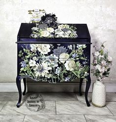 an ornate painted dresser with flowers on it