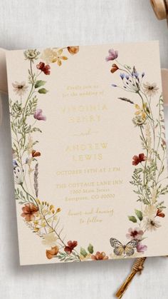 a wedding card with flowers and butterflies on it