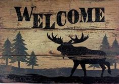 a wooden sign that says welcome with an image of a moose