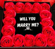 a box that has roses in it with the words will you marry me?