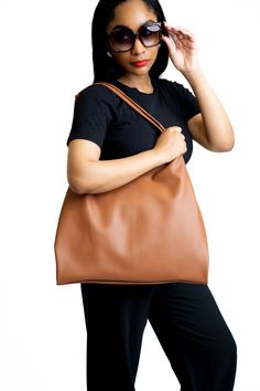 The perfect versatile everyday classic bag. Large enough to throw all of your everyday essentials in and go. FEATURES Golden metal clip lock closure Adjustable shoulder straps Internal pocket with card holder Pebbled vegan leather, soft vegan suede internal lining Size: 15.7"" L x 13""H x 2"" D Classic Solid Color Hobo Bag For Daily Use, Versatile Brown Hobo Bag With Smooth Grain, Versatile Hobo Bag With Smooth Grain For Everyday Use, Versatile Cognac Shoulder Bag With Smooth Grain, Versatile Hobo Bag For Everyday Use With Smooth Grain, Versatile Smooth Grain Hobo Bag For Everyday Use, Versatile Brown Smooth Grain Hobo Bag, Cognac Smooth Grain Versatile Shoulder Bag, Versatile Cognac Hobo Bag For Everyday Use