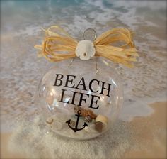 a glass ornament with an anchor on the beach