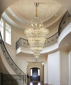 an elegant entry way with chandelier and staircase leading up to the second floor