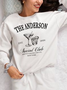 Custom Name Place Date Crewneck Sweatshirt and Hoodie is the perfect wedding gift! The new bride will be cozy yet chic while honeymooning in this minimalistic, Vintage Party style sweater.  Personalized Sweatshirt or Hoodie with the wedding Memories makes even more special. ⚫How to Custom: 🞂Head Name: {The Anderson} 🞂Est. Year: 2024 🞂Select Drinks: 1 or 2 or 3 {1, 2 or Multiple Drinks Together} 🞂Place: Example: Beach/Social Club/Winery 🞂Bride Name: Anette 🞂Location: Las Vegas/ New York 🞂M Custom Wedding Sweatshirts, Wedding Sweatshirts, Vintage Party, Perfect Wedding Gift, Shower Bebe, Etsy Bridesmaid Gifts, Social Club, Wedding Memorial, Colorful Hoodies