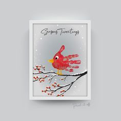 a red bird sitting on top of a tree branch next to a handprint sign