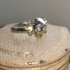 When ordering, please give us your phone number for safer Fedex shipping! RING SIZE:   12 US, 67 EU [FREE RESIZING] SILVER WEIGHT: 1.7 grams Unleash your inner pirate and make a bold statement with our Vintage Silver Skull Band Ring! This stackable piece is not just a ring, but a work of art that combines edgy aesthetics with intricate craftsmanship. The meticulously carved skull, adorned with crossbones, serves as a reminder of the fearless spirit within you. Made from high-quality silver, this ring promises durability and comfort without compromising style. Whether you're channeling your inner buccaneer or simply looking for a unique piece to add to your collection, the Vintage Silver Skull Band Ring is the treasure you've been seeking!    Your item will come boxed and wrapped carefully, Gift White Gold Hallmarked Skull Ring, Adjustable Skull Ring For Anniversary, Adjustable Round Skull Ring For Anniversary, Gift Skull-shaped Hallmarked Rings, Vintage Nickel-free Skull Ring For Gift, Nickel-free Skull Rings For Gift, Vintage Nickel-free Skull Ring Gift, Vintage Open Skull Ring, White Gold Skull Rings For Gifts