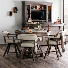 a dining room table with chairs and a television