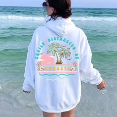 Soak up the serene vibes with our Sunset Summer Hoodie. This cozy sunset hoodie, perfect for beach lovers, captures the beauty of a beach sunset. Ideal for those who are easily distracted by sunsets, this beach sweatshirt blends comfort with a stunning sunset design. Elevate your beachy aesthetic and enjoy the perfect evening with our Sunset Sweatshirt. Whether you're strolling along the shore or relaxing at a bonfire, this beach hoodie is a must-have for your summer wardrobe. White Letter Print Hoodie For Beach Season, Casual White Hoodie For Beach Season, White Long Sleeve Hoodie For Beach, Casual Relaxed Fit Hoodie For Vacation, Casual Hoodie With Relaxed Fit For Vacation, White Beach Hoodie Sweatshirt, White Letter Print Hoodie For Beach, Vacation Hoodie With Relaxed Fit And Long Sleeves, White Hoodie Sweatshirt For Beach