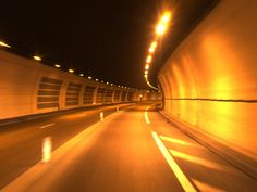 a car driving through a tunnel at night