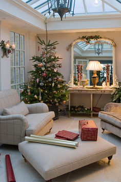 a living room filled with furniture and a christmas tree