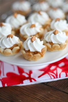 small desserts with whipped cream and nuts on a plate