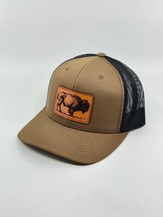 Bison Snapback Trucker Hat Full Grain Leather Patch Our patches are crafted exclusively from premium USA sourced full-grain English Bridle leather, known as one of the highest-quality vegetable-tanned leathers worldwide. Our leather guarantees superior quality, durability, and rich finishes. Each patch is applied by hand in our Califonia workshop using our proprietary adhesion process. This exceptionally strong bond is designed to withstand anything you throw at it. Snapback Trucker Hat: * One s Brown Flat Bill Hat For Rodeo, Outdoor Brown Hats With Leather Backing, Brown Hats With Leather Backing For Outdoor, Classic Brown Trucker Hat For Outdoor, Outdoor Brown Hat With Leather Backing, Brown Hat With Leather Backing For Outdoor, Vintage Brown Hat With Logo Patch, Adjustable Leather Snapback Hat In Brown, Brown Leather Snapback Hat