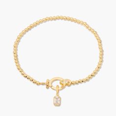 Treat your wrists to some bling with the Mackenzie Birthstone Bracelet. With a vivid birthstone charm, and intricately-beaded gold, this sparkling accessory is sure to add a touch of glam to any outfit. Avery Bracelet: Available in 14k gold plated or rhodium plated brass, 6" bead bracelet, hinge closure measures 1/2", 4mm beads Mackenzie Hinge Birthstone Charm: Available in 14k gold plated sterling silver or rhodium plated sterling silver1/8"x1/4" charm, 5mm Cubic Zirconia NOTE - open bracelet h Gold Charm Bracelet With Cubic Zirconia, Gold Cubic Zirconia Bracelet With Charms, Gold Cubic Zirconia Charms Bracelets, Adjustable Gold Bracelets With Sparkling Stones, Elegant Crystal Charm Bracelet As A Gift, Elegant Crystal Bracelet With Charms For Gift, Elegant Crystal Charm Bracelet Gift, Gold Cubic Zirconia Beaded Bracelets As Gift, Dainty Gold Bracelet With Sparkling Stones