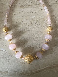 Rose Quartz Necklace featuring 14MM faceted rondelle rose quartz stones, 8MM smooth round rose quartz stones accented with Bali style gold over copper beads and 6MM Swarovski crystals.  Gold filled toggle clasp.  Necklace is handmade and measures 18 inches. GIFT BOXED Rose Quartz Necklace Rope, Toggle Clasp Necklace, Quartz Choker, Stone Beaded Necklace, Hippie Necklace, Rose Quartz Necklace, Handmade Fashion Jewelry, Rose Quartz Beads, Rose Quartz Stone