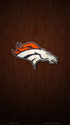 the denver football team logo on a wooden background