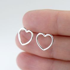 Heart stud earrings Sterling silver Open heart studs Heart earrings Silver love earrings Empty heart studs Love studs Minimalist earrings. ★Sold in pair. Materials: Heart, stud and earring backs are in sterling silver 925. Dimensions: Heart 10mm. Before ordering please see my shop policies for important information: www.etsy.com/shop/Katstudio/policy Thank You! Katherine Minimalist Heart Charm Earrings For Valentine's Day, Silver Minimalist Heart Charm Earrings, Silver Minimalist Heart Earrings With Charm, Minimalist Silver Earrings With Heart Charm, Silver Minimalist Heart Earrings, Minimalist Silver Heart Earrings Nickel Free, Minimalist Silver Heart Earrings, Nickel-free, Minimalist Open Heart Earrings For Pierced Ears, Minimalist Open Heart Pierced Earrings