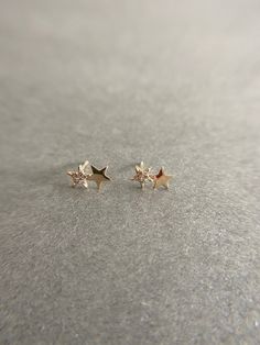 14K Solid Gold Tiny CZ Two Star Stud Earrings - 14K Solid Gold Quantity: One Pair Color : Gold Materials : 14K Solid Yellow Gold Size : 6mm*10mm *14K Solid Yellow Gold will not tarnish. *Good for sensitive skin. * Metal components are 14K Solid Yellow Gold including earring backs. * Suitable for delicate and sensitive ears. * Comes in a jewelry box. If you need extra boxes for gifting....just let us know! Gold Star Earrings With Diamond Accents, Gold Star-shaped Earrings With Diamond Accents, Gold Diamond Star Earrings, 14k Yellow Gold Sparkling Earrings, Sparkling 14k Yellow Gold Earrings, 14k Gold Sparkling Earrings, Sparkling 14k Gold Earrings, Star Stud Earrings, Star Earrings Stud