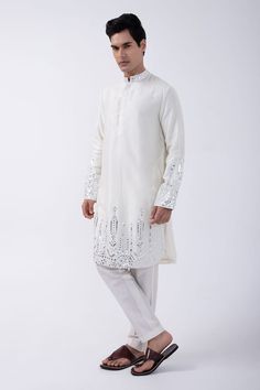 Ivory kurta with mirror embellished patterns on hem. Comes with pyjama. - Aza Fashions Luxury White Kurta With Mirror Work, White Kurta With Mirror Work For Diwali, White Sherwani With Mirror Work For Eid, Off White Kurta With Gota Work For Eid, White Mirror Work Kurta For Diwali, Off White Kurta With Mirror Work For Festivals, Diwali White Kurta With Mirror Work, Festive Off-white Kurta With Mirror Work, Off White Mirror Work Kurta For Designer Wear