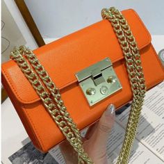 Experience a pop of color with our Sasha Shoulder Bag! Available in vibrant orange and yellow, this solid color lock bag is the perfect accessory to add a touch of fun to any outfit. Carry your essentials in style and make a statement with this trendy and versatile shoulder bag. Chains Accessories, Women's Bags By Usage, Pu Bag, Accessories Bag, Mode Casual, Patchwork Patterns, Orange Bag, Orange Fashion, Fashion Pattern