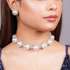 With this Manish Malhotra Jewelry Inspired Pearl diamond necklace, you can try to recreate Princess Diana's timeless elegance. Embrace sophistication with this Pearl Statement Necklace inspired by Princess Diana's iconic style. Choose the Pearl Choker or Pearl Bridal Necklace for a classic and refined look. These exquisite pieces combine the lustrous beauty of pearls with the sparkle of diamonds, adding a touch of regal charm to any bridal ensemble. *𝐏𝐑𝐎𝐃𝐔𝐂𝐓 𝐃𝐄𝐓𝐀𝐈𝐋* * Material: Brass * Plating: White Rhodium Plated * Stone: AAA-quality CZ diamond & Pearls. *𝐃𝐈𝐌𝐄𝐍𝐒𝐈𝐎𝐍𝐒*  Necklace * Weight: 56 gm * Length: 8.5 Inches * Width: 0.7 Inches * Height: 0.6 Inches  Earrings * Weight: 7 gm each * Length: 0.6 Inch * Width:  0.6 Inches * Closure: Push Back *𝐒𝐇𝐈𝐏𝐏𝐈𝐍𝐆 𝐏𝐎 Silver Pearl Embellished Jewelry Sets For Wedding, Diamond White Round Bridal Necklace For Party, Diamond Pearl Drop Jewelry For Party, Silver Pearl Jewelry Sets For Party, Diamond Pearl Drop Necklace For Wedding, Party Pearl Jewelry Sets In Silver, Party Jewelry With Diamond And Pearl Drop, Party Pearl Silver Jewelry Sets, Glamorous Round Pearl Jewelry