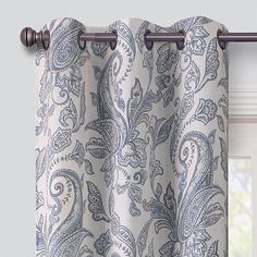 a curtain with a blue and white paisley print on it