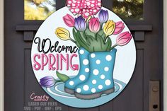 a welcome spring sign with flowers in a blue boot