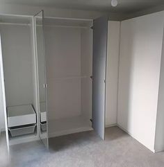 an empty room with white walls and closets