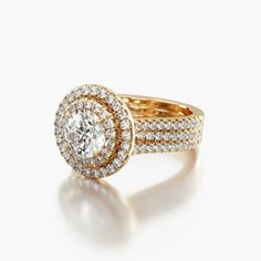 a yellow gold ring with two rows of diamonds on the band and an oval shaped center