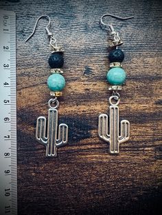 Dangling turquoise bead w/black lava bead and cactus earring. The hook that goes into your ears is .925 sterling silver. Cactus Earrings, Earring Designs, Le Crochet, Lava Bead, Turquoise Beads, Diy Earrings, Designer Earrings, Jewelry Earrings Dangle, Beaded Jewelry