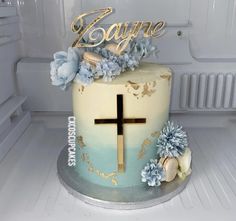 a cake decorated with flowers and a cross