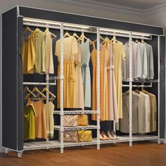 a closet filled with lots of different colored shirts and dresses on hangers next to a wooden floor