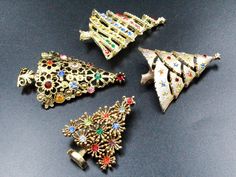 DESCRIPTION: This vintage jewelry lot is a dazzling collection of holiday-themed brooches. Each of the four brooches features a meticulously crafted Christmas tree made from radiant gold-tone metal, adorned with a captivating array of multi-colored rhinestones. With all pieces in excellent condition, this collection is a treasure trove of festive elegance, ready to add a touch of seasonal charm and sparkle to any outfit or occasion. NOTE: Insurance fee and handling fee are included in the shippi Christmas Tree Gold, Holiday Christmas Tree, Heart Dangle Earrings, Holiday Christmas, The Four, Gold Tone Metal, Multi Colored, Christmas Holidays, Christmas Crafts