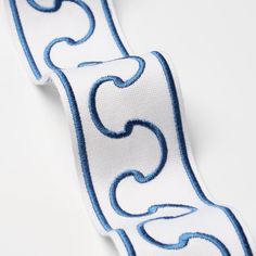 a white and blue ribbon with swirls on it