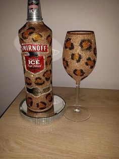 a bottle and glass sitting on top of a table