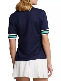 The RLX Ralph Lauren Tailored Fit Cricket Polo Shirt stands out with cricket-inspired stripes adorning its neckline and cuffs. Made from a cotton-blend jersey, this polo shirt offers softness and features the 'RXL' logo on the right shoulder, while its tailored fit showcases a slim silhouette with a gentle taper..Spread collar.Short sleeves.Pulls over.54% polyester/46% cotton.Imported.SIZE & FIT.Shoulder to hem: about 25'.Model measurements: 5'10' tall.Model is wearing a US size Small.The RLX Ralph Lauren Tailored Fit Cricket Polo Shirt stands out with cricket-inspired stripes adorning its neckline and cuffs. Made from a cotton-blend jersey, this polo shirt offers softness and features the 'RXL' logo on the right shoulder, while its tailored fit showcases a slim silhouette with a gentle ta Sporty Striped V-neck Top, Navy Sporty Top With Three Stripes, Cotton Golf Tops With Contrast Stripes, Casual Golf Tops With Contrast Stripes, Navy Fitted Top With Contrast Stripes, Navy Sporty Top With Contrast Stripes, Cotton Sports Tops With Signature Stripes, Sporty Golf Tops With Three Stripes, Navy Cotton Top With Striped Cuffs