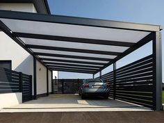 a car is parked in the driveway under an awning that covers it from sun