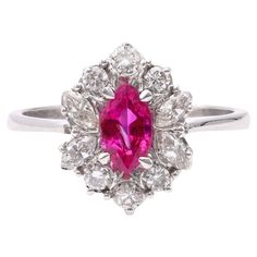 One Vintage Ruby Diamond 18k White Gold Cluster Ring. Featuring one marquise cut ruby weighing approximately 0.55 carat. Accented by six round brilliant and four marquise cut diamonds with a total weight of approximately 0.25 carat, graded near-colorless, SI clarity. Crafted in 18 karat white gold with purity mark. Circa 1990. The ring is a size 6 ¼ and may be resized. About this Item: Transport yourself to the glamorous era of the 1990s with this stunning vintage ruby and diamond cluster ring. Marquise Cut Diamond, Ruby Diamond, Diamond Cluster Ring, Ring Fit, Marquise Cut, Diamond Cluster, Cluster Ring, Round Brilliant, Everyday Fashion